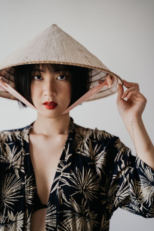 Free Elegant portrait of a young East Asian woman wearing a sakkat hat against a white background. Stock Photo