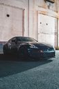 Sports car parked near shabby building
