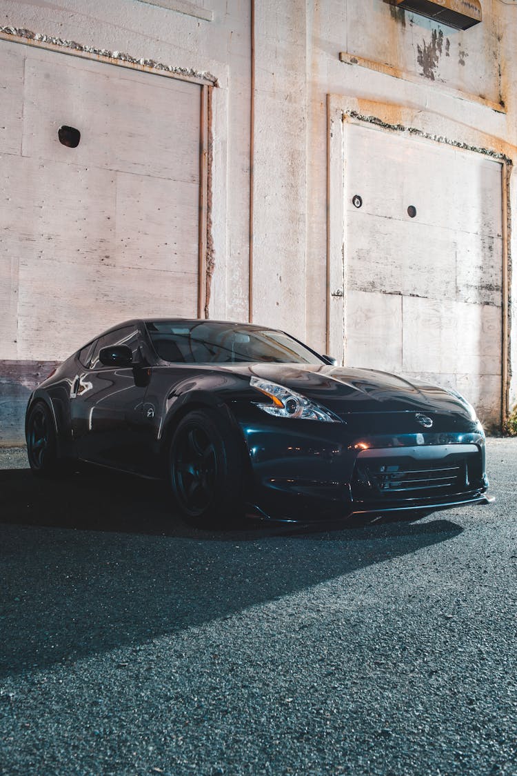 Sports Car Parked Near Shabby Building