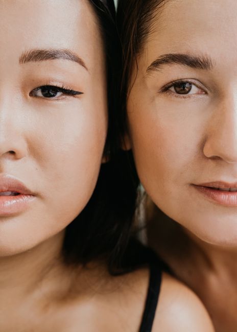 Intimate close-up of two women's faces showcasing beauty and diversity.