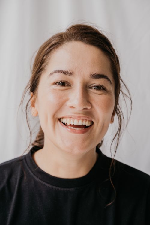 Free A joyful woman with a radiant smile, captured in a well-lit portrait indoors. Stock Photo