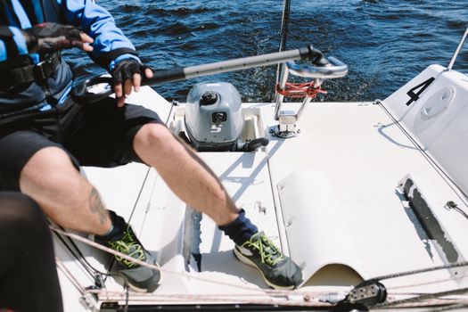 Person in Blue and Black Jacket Riding on White Boat