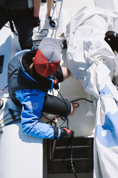 Man in Blue Jacket Wearing Red Helmet