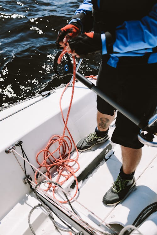 Person in Blue Shirt and Black Shorts Standing on Boat