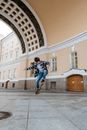 Man in Blue Denim Jacket and Blue Denim Jeans Jumping on Mid Air