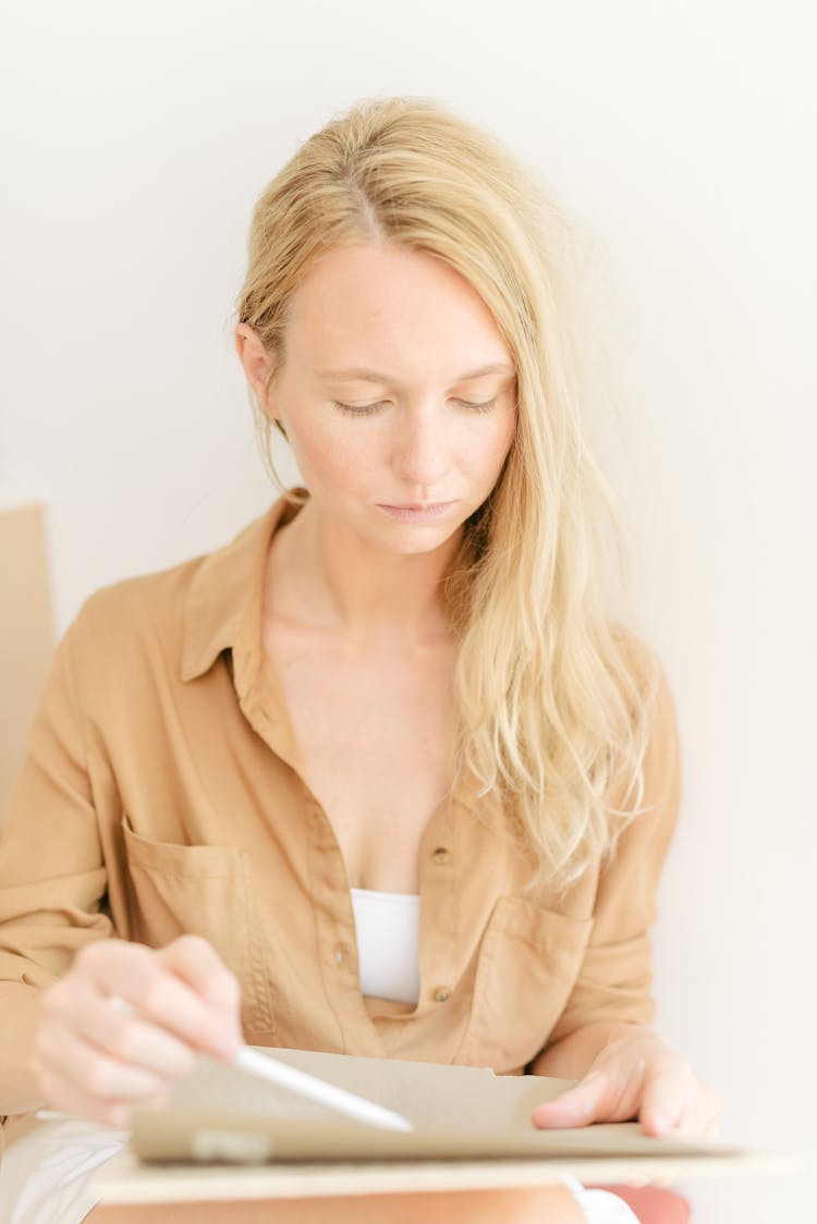 A Woman Sketching On Paper