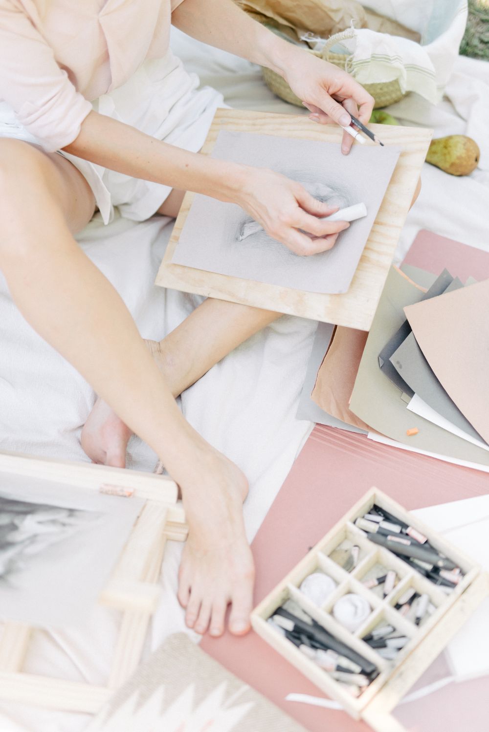 A person sketching with drawing materials
