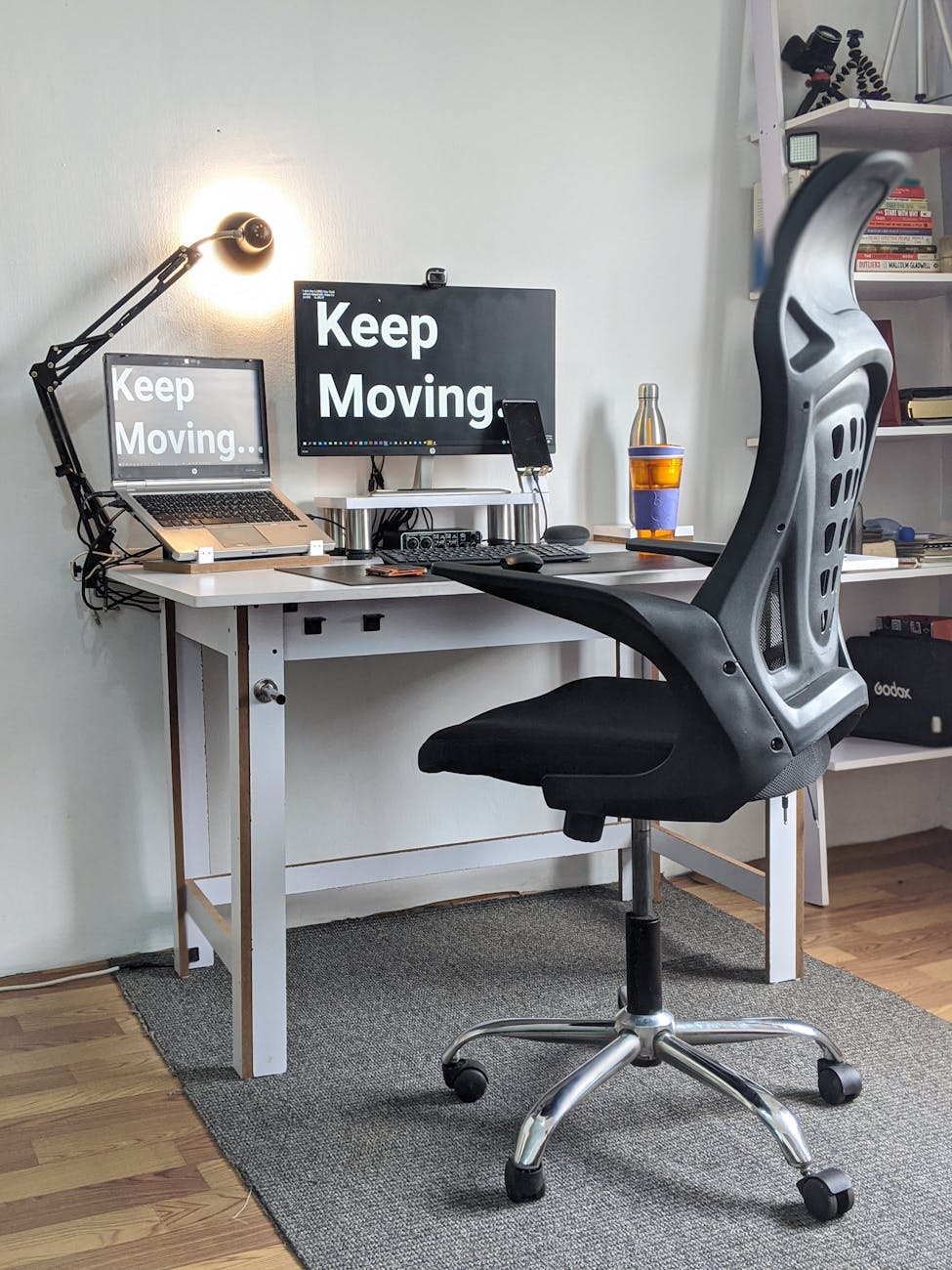 ergonomic office chair with a text screen saver that reads "keep moving"