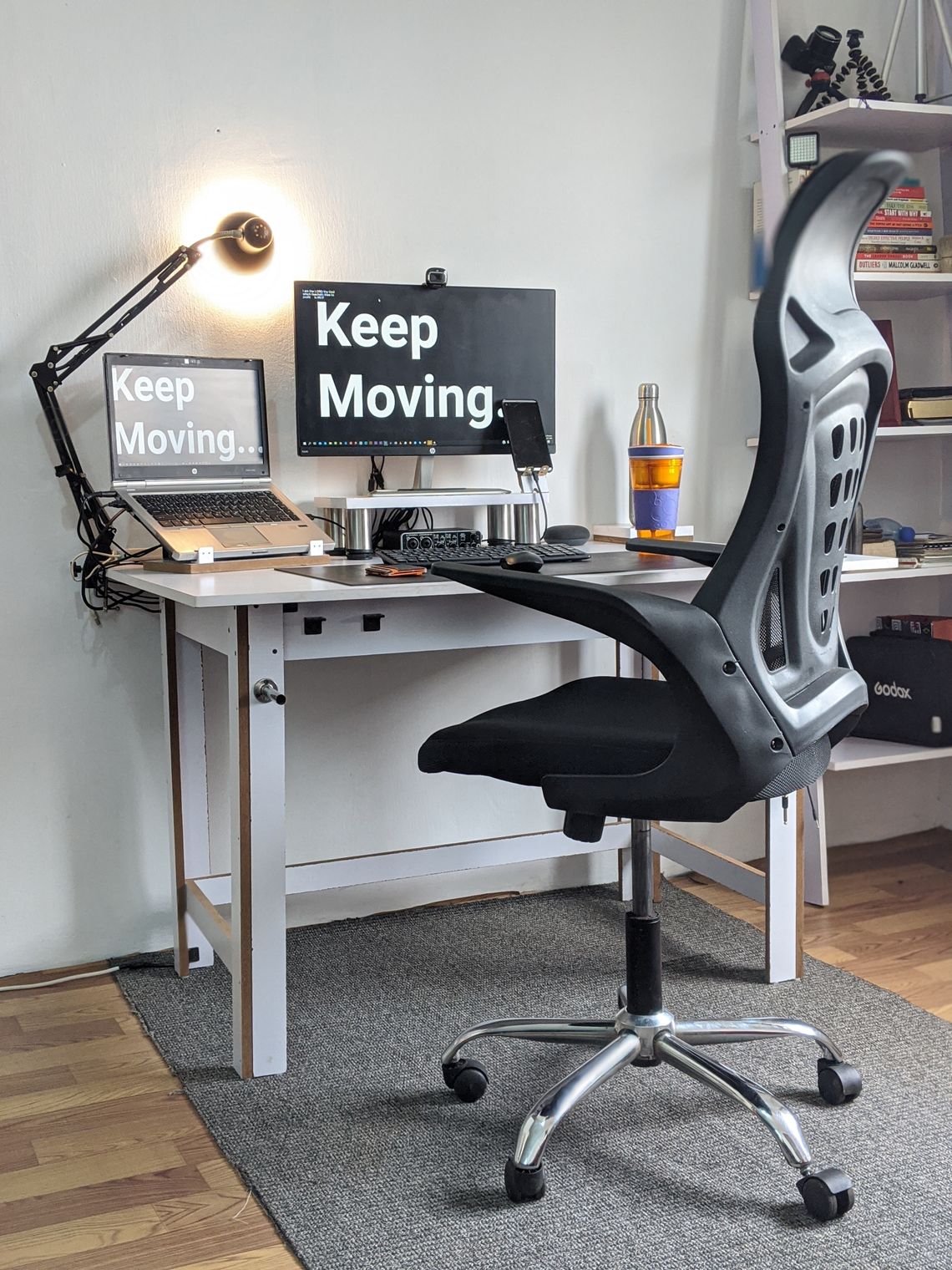 Stylish home office with ergonomic chair, desk and organized computer setup