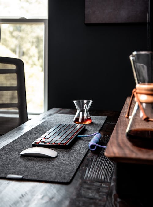 Free A Laptop Keyboard Between a Mouse and Drinking Glass Stock Photo