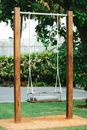A Cushioned Swing Hanging on a Steel Bar