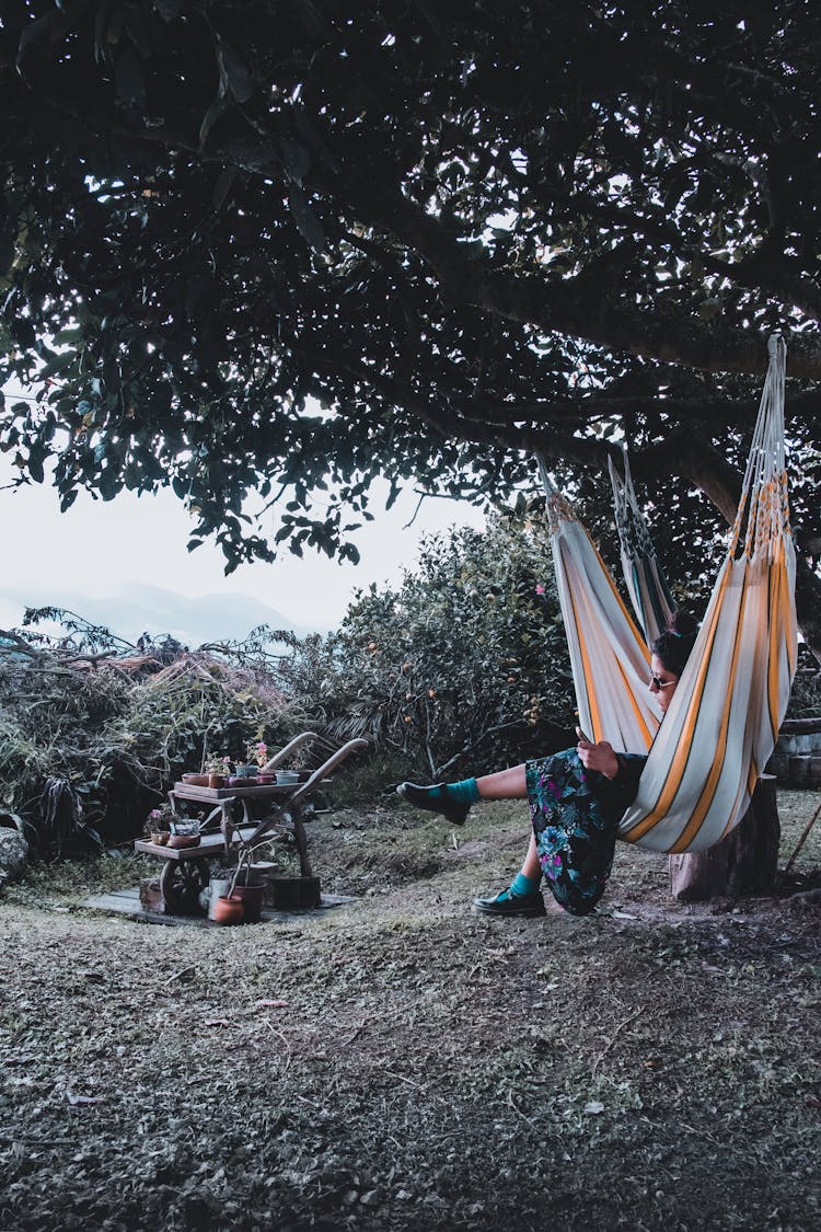 A Woman Sitting On Hammock Hanging On A Tree