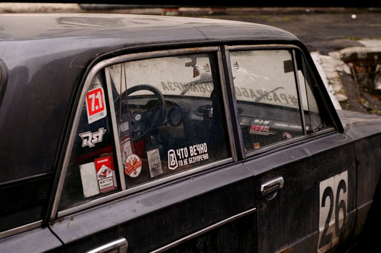 Old Timer Car With Bright Stickers On Street