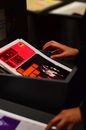 Person Holding White and Red Book