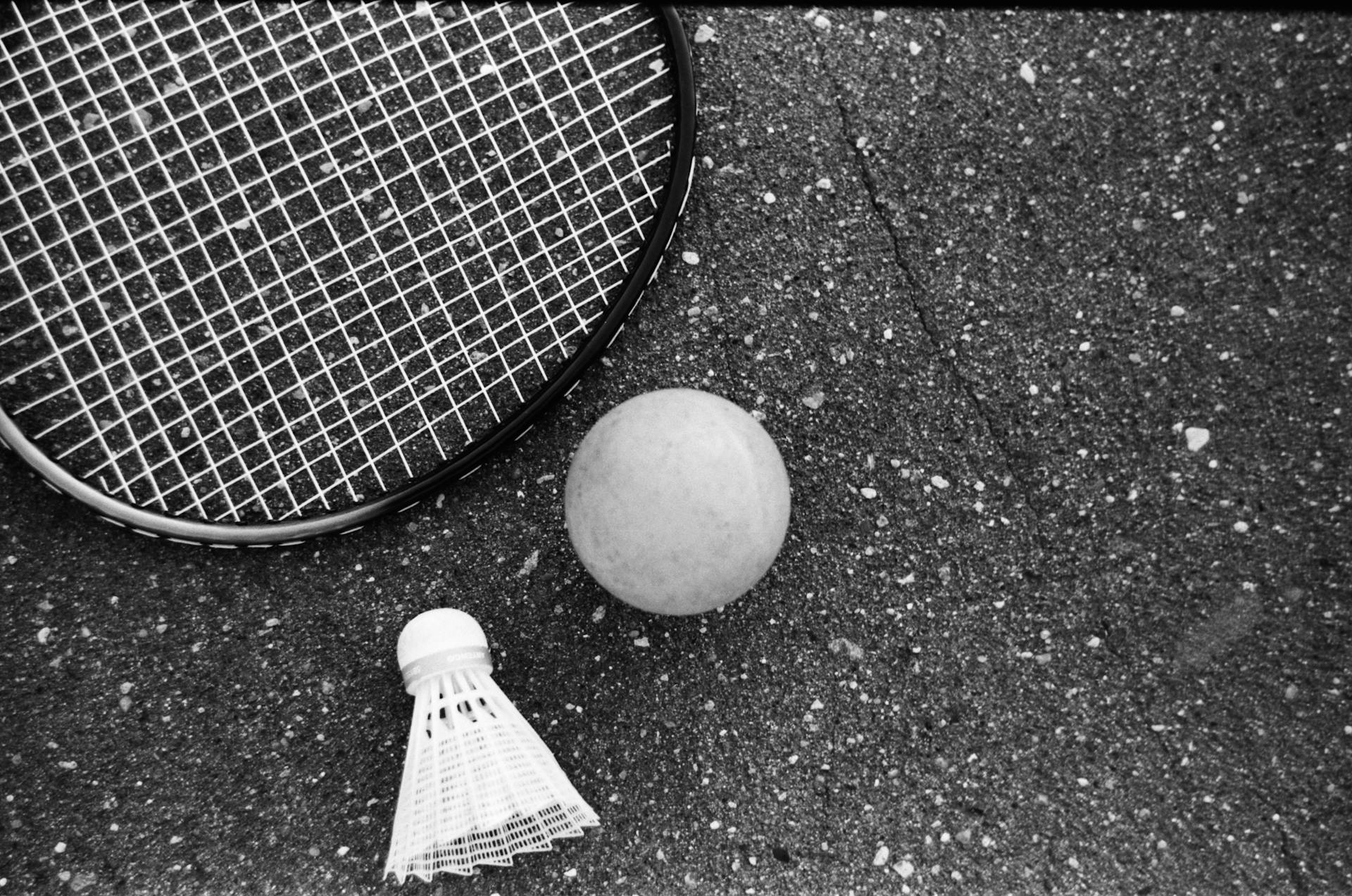 Tennis equipment placed on rough asphalt road