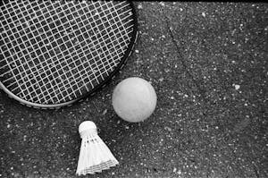 Tennis equipment placed on rough asphalt road
