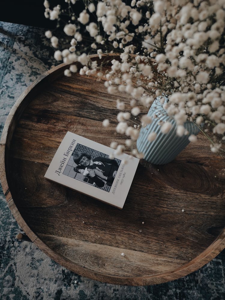 A Book On A Round Wooden Tray