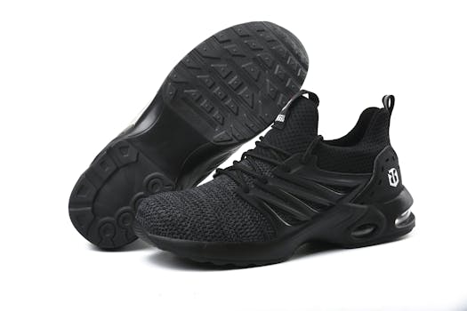 Stylish black running sneakers showcased on a minimalistic white background.