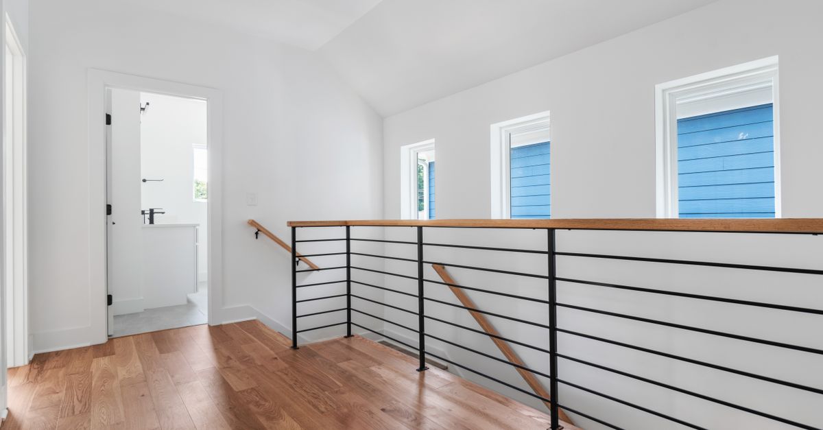 A bright and stylish hallway with wooden floors and modern design elements.