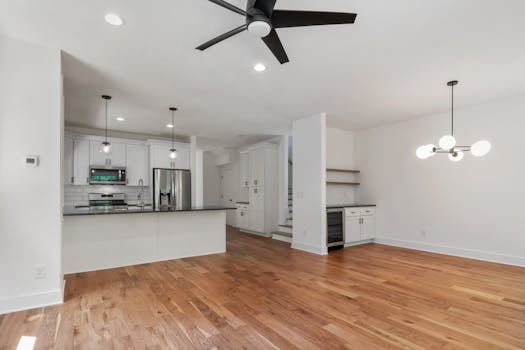 Bright and open modern kitchen with stylish lighting and wood flooring.