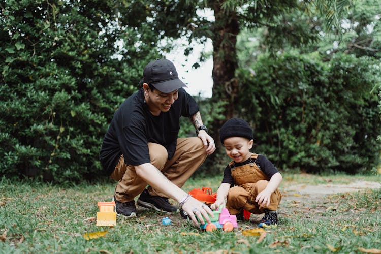 Father And Son Playing In The Yard 