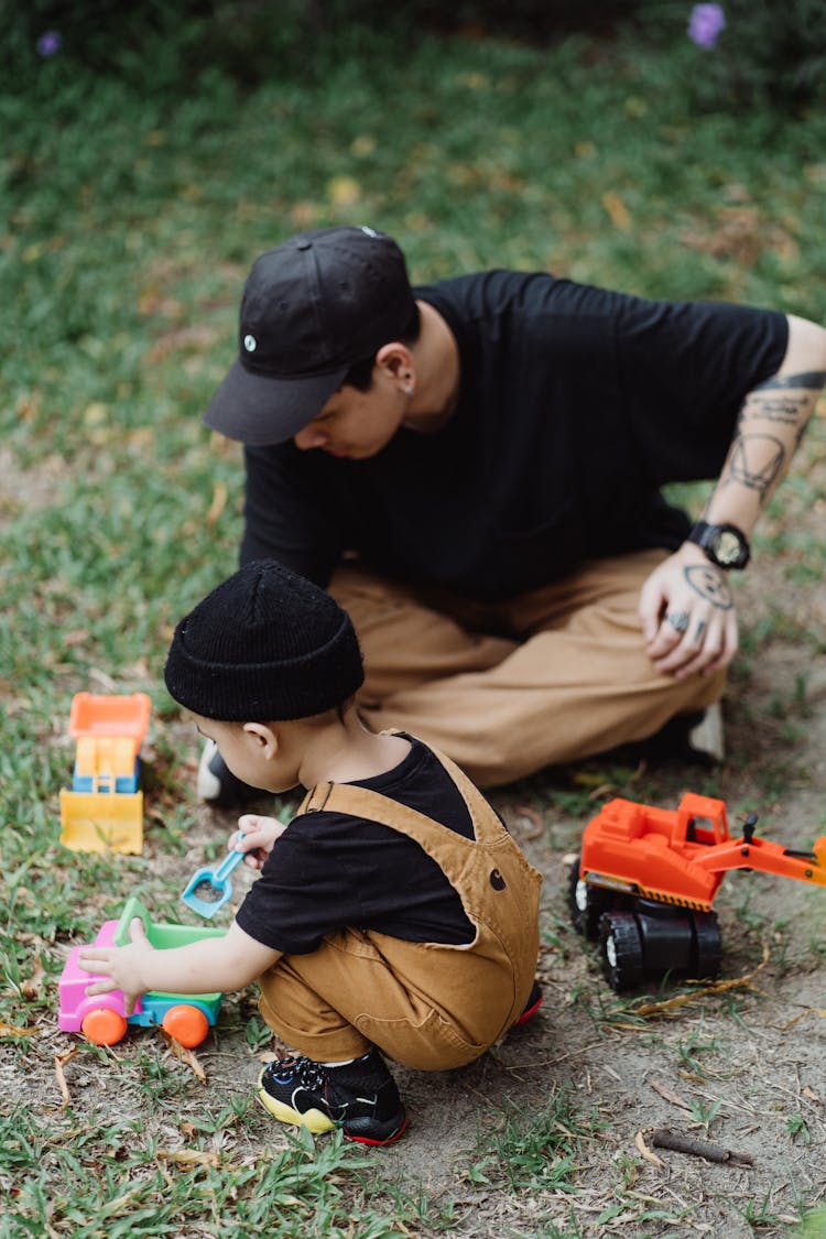 Father And Son Playing In The Yard