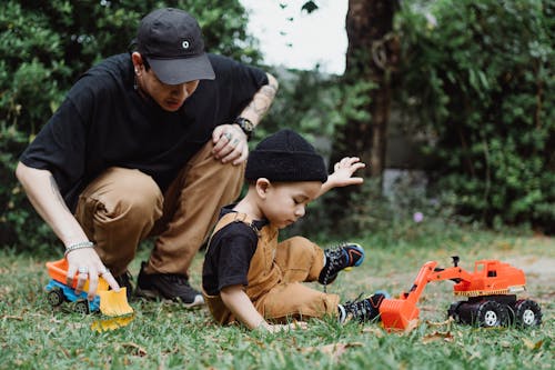 Father with Son Playing on Grass