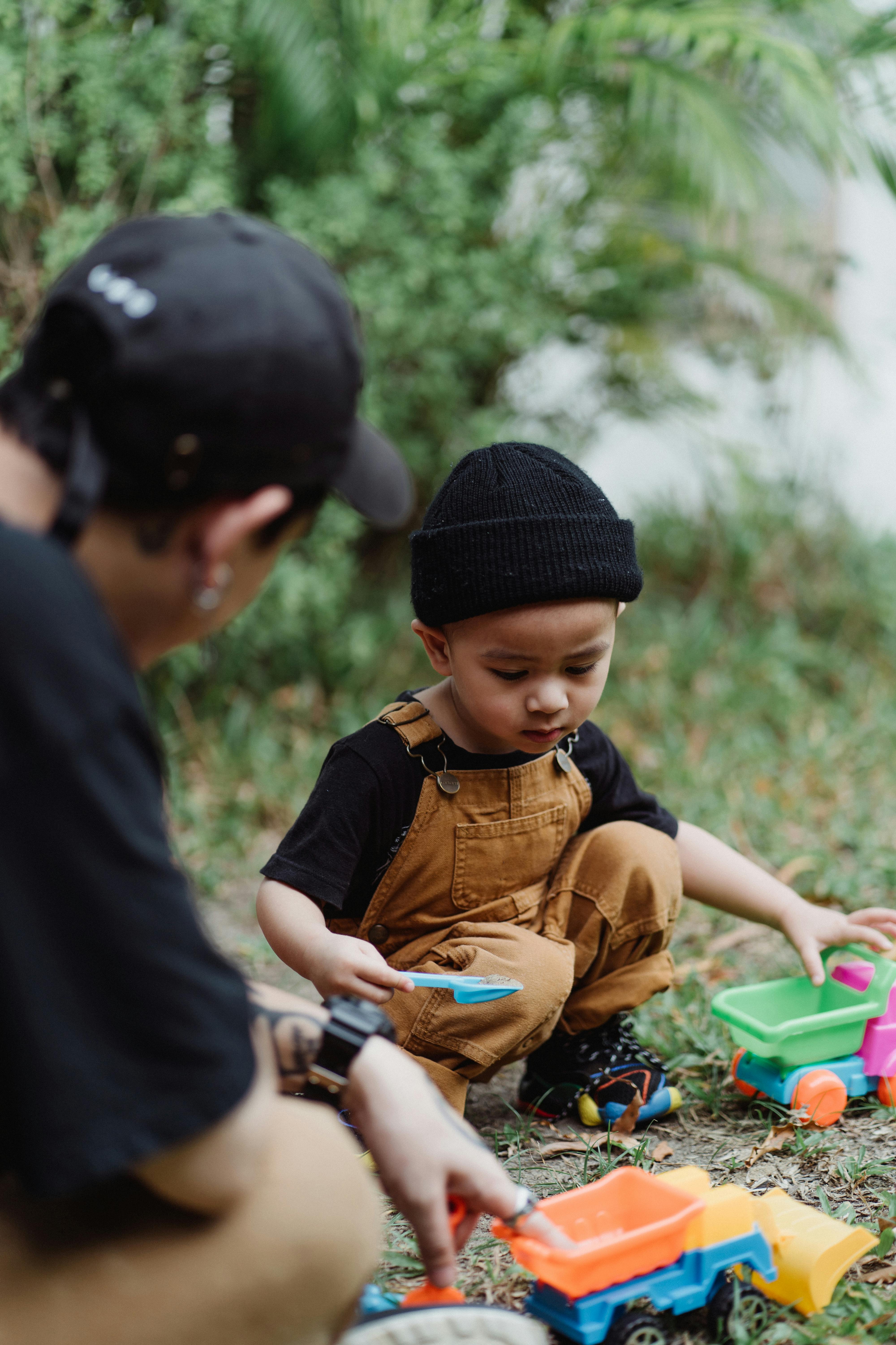 father and little boy playing with toys