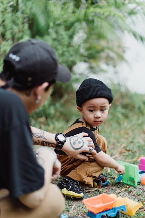 Father and Son Playing in the Yard with Toys 