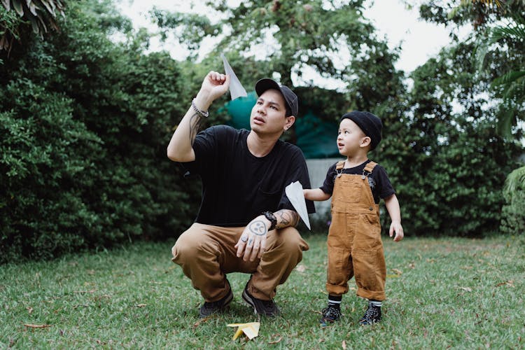 Man And Child Throwing Paper Airplanes