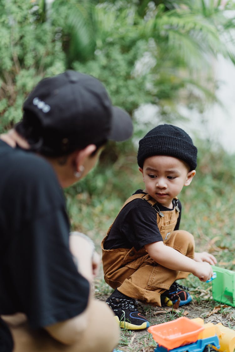 Father Playing With His Son In The Yard