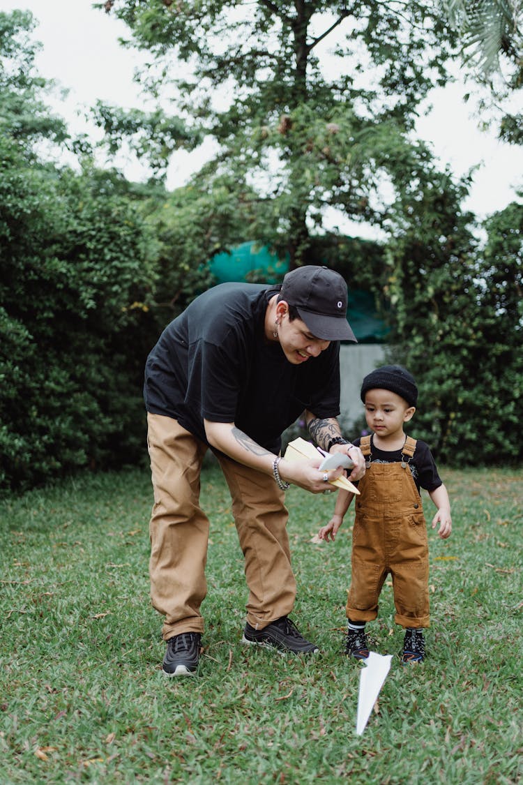 Father And Son Playing In The Garden 