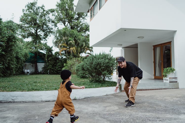 Boy Running In Arms Of His Father