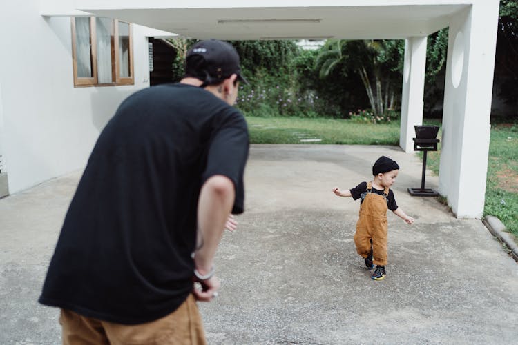 Father Looking At Son Running 