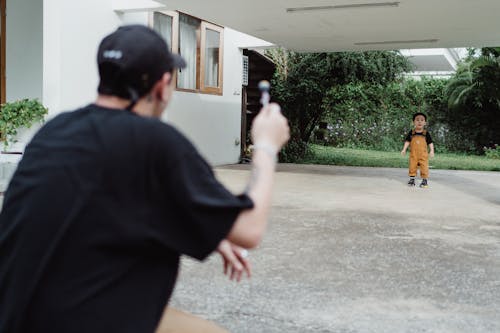 Free Father and Son Playing in Driveway Stock Photo