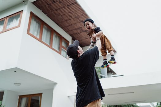 Man Holding Boy aloft 