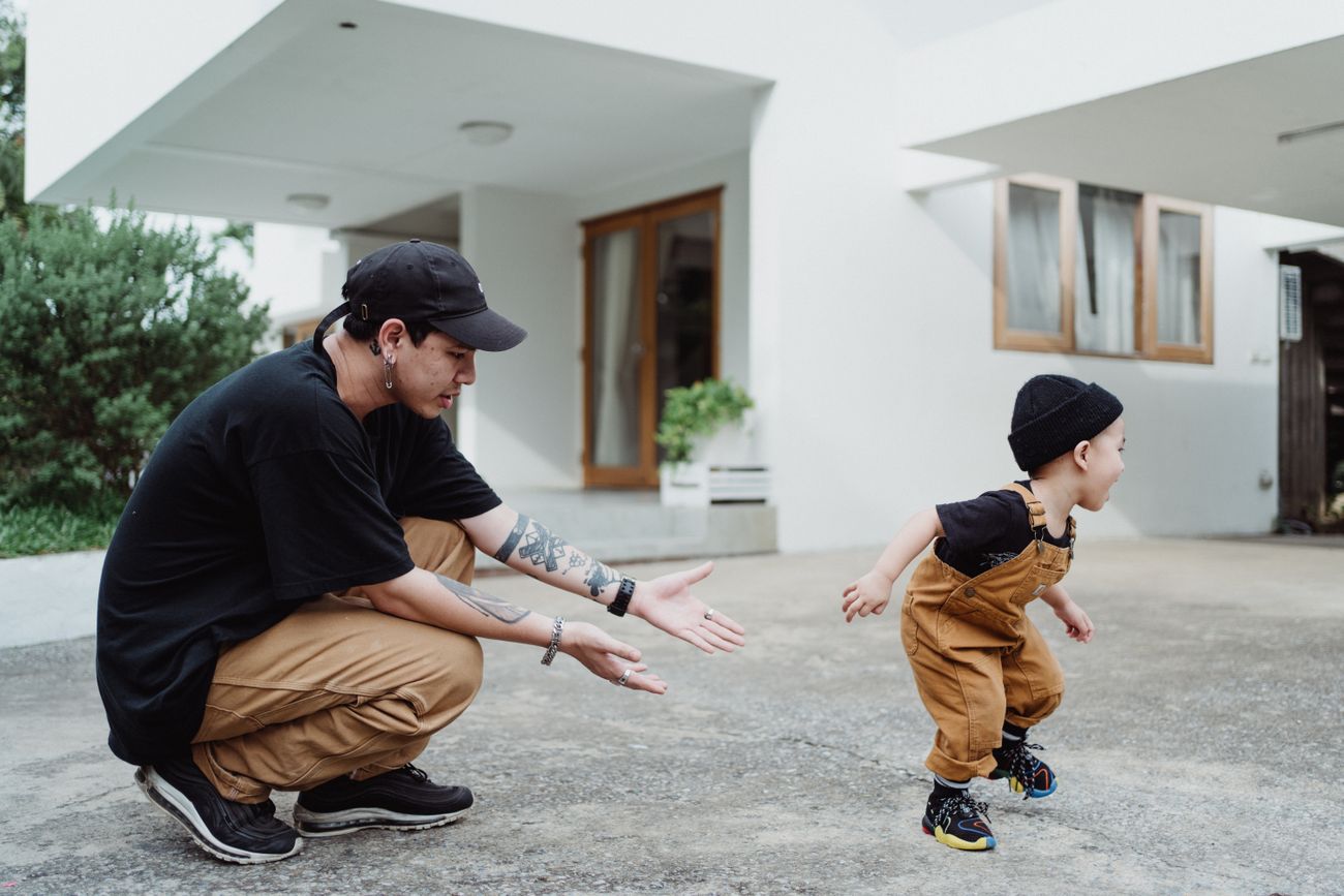 Father playing with young child outdoors