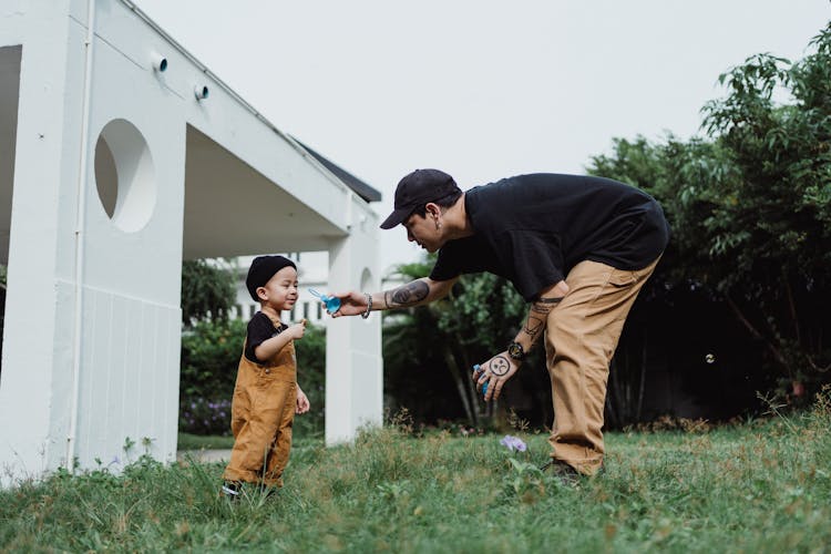 Man Playing With Son In Patio 