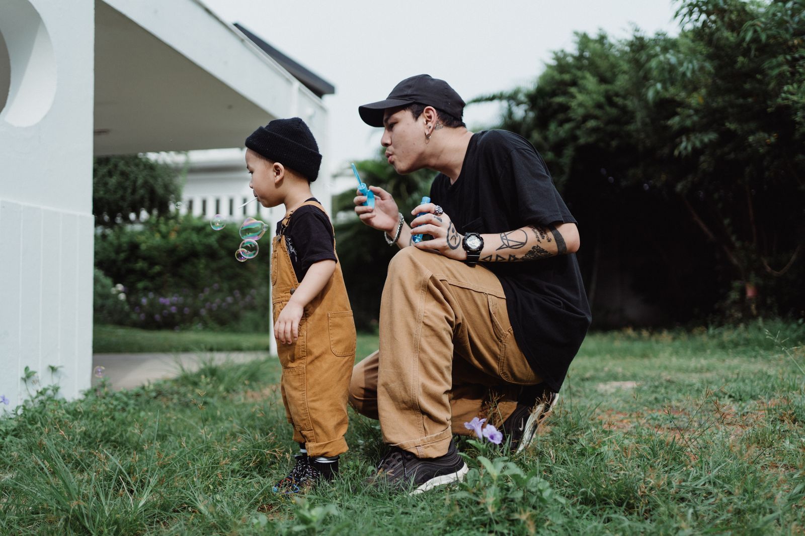 A dad playing with his kids in the yard