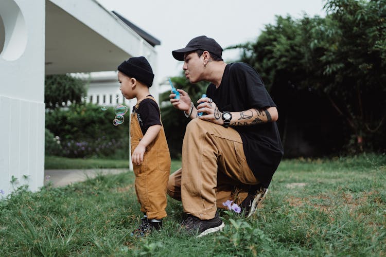 Father And Son Playing In The Yard