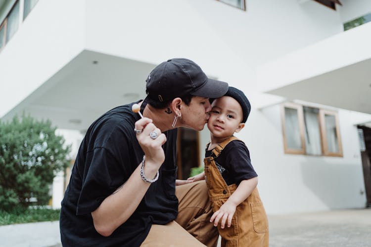 Father Kissing Son On Cheek