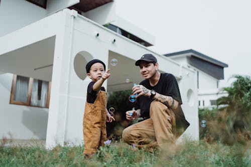 Father and Son Playing with Soap Bubbles 