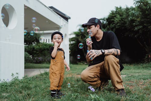 Father and Son Blowing Soap Bubbles 