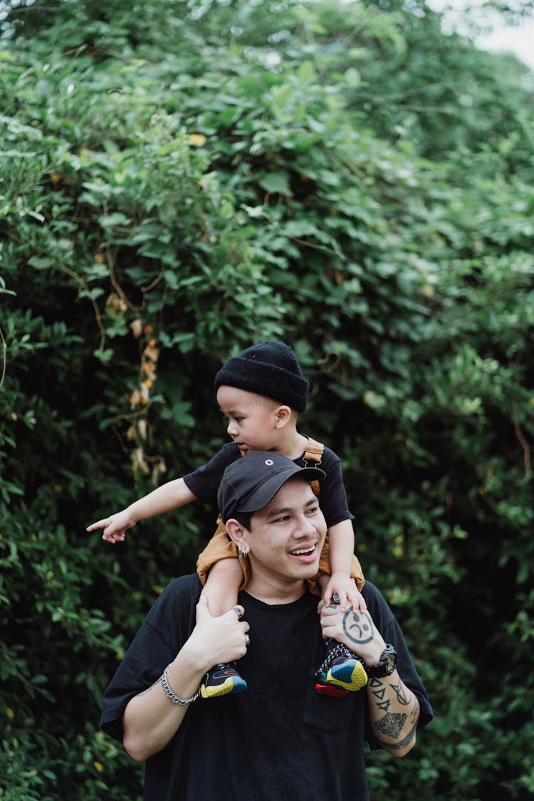 Father Carrying His Son On Shoulders