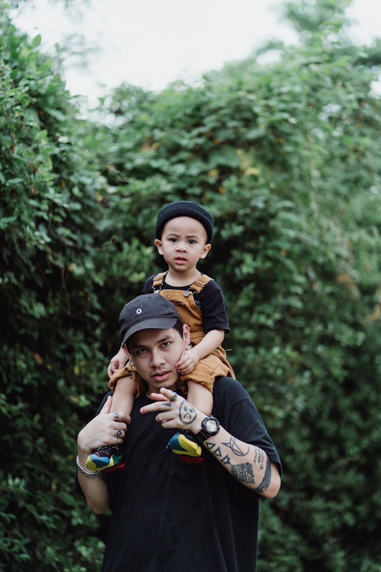 Man Carrying Boy On Shoulders