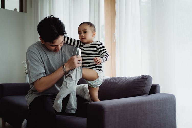 Father Dressing His Son 