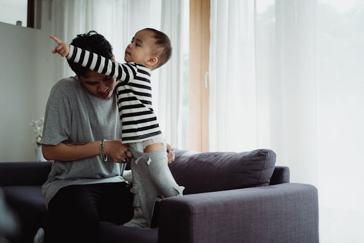 Father Dressing Up His Son 