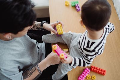 Parent and child building with colorful blocks together