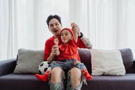 Girl in Red Crew Neck T-shirt Sitting on Gray Sofa