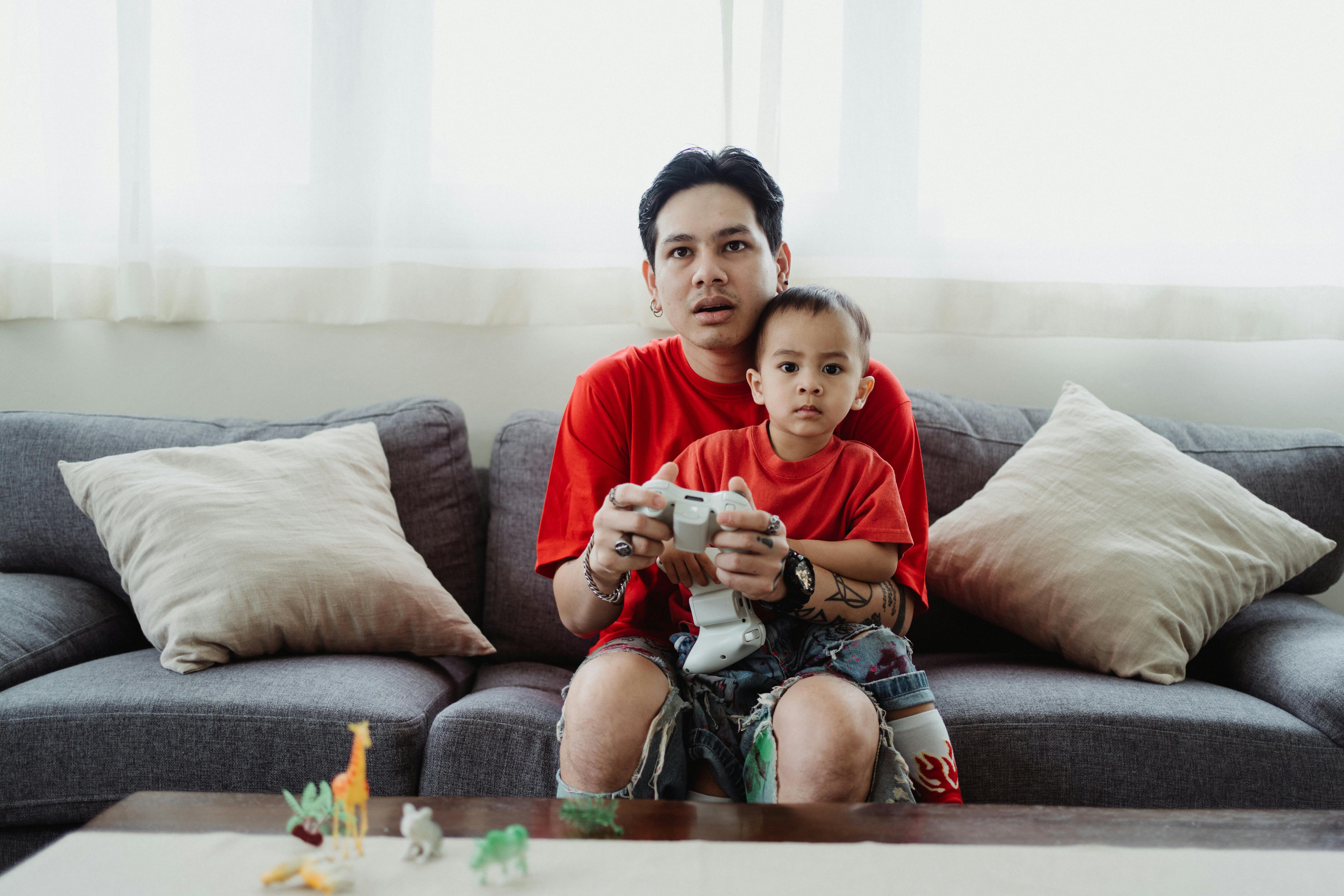 father and son playing a video game